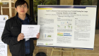 Jingwei Sun stands with research poster