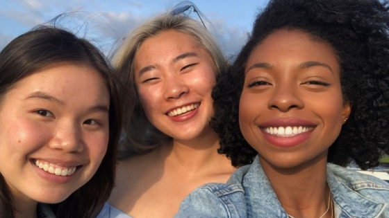 group of three smiling students