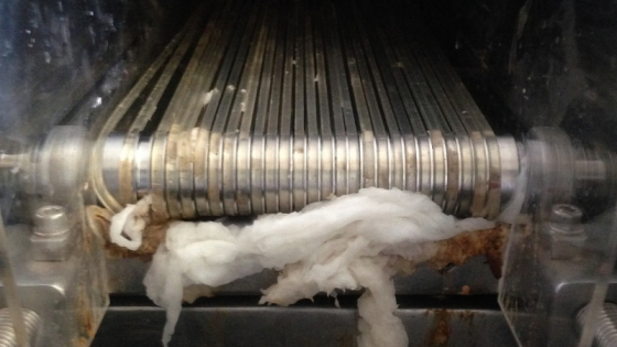 A conveyor belt jammed up with wet toilet paper