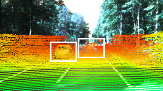 Lines of green, yellow, and orange overlay an image of a car on a road along with a transparent version of the car 