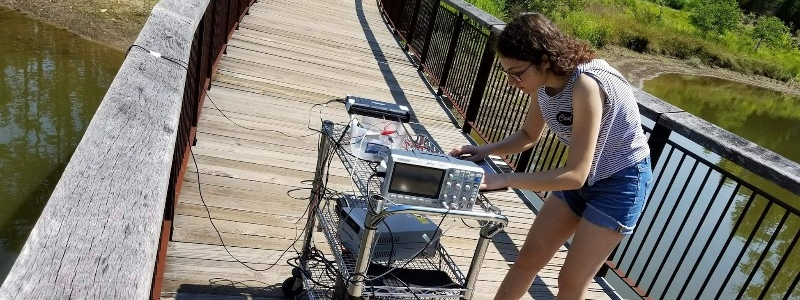 Electrical and electronics engineering student Sueda Taner tests her sonar project at the Duke Reclamation Pond 