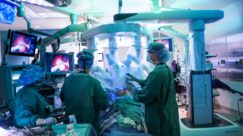 surgeons with robotic equipment in an operating room