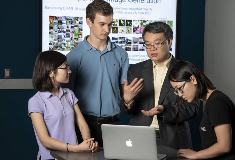 Yiran Chen with students at computers