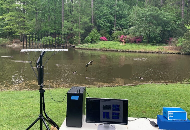 Electronics set up on a folding table by a pond