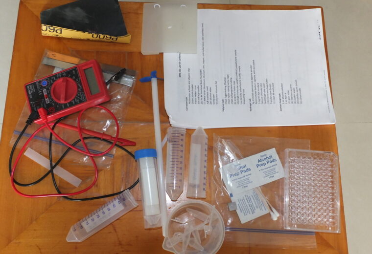 A table top with a bunch of equipment and paper