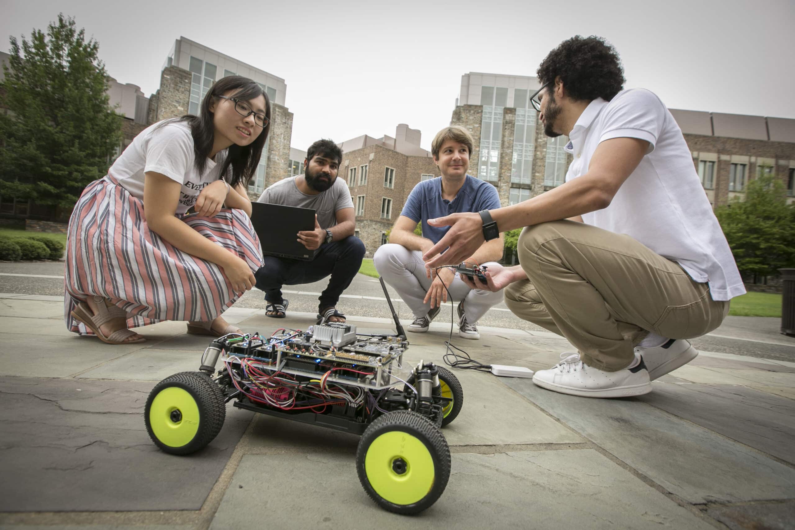 Miroslave Pajic with students and robot