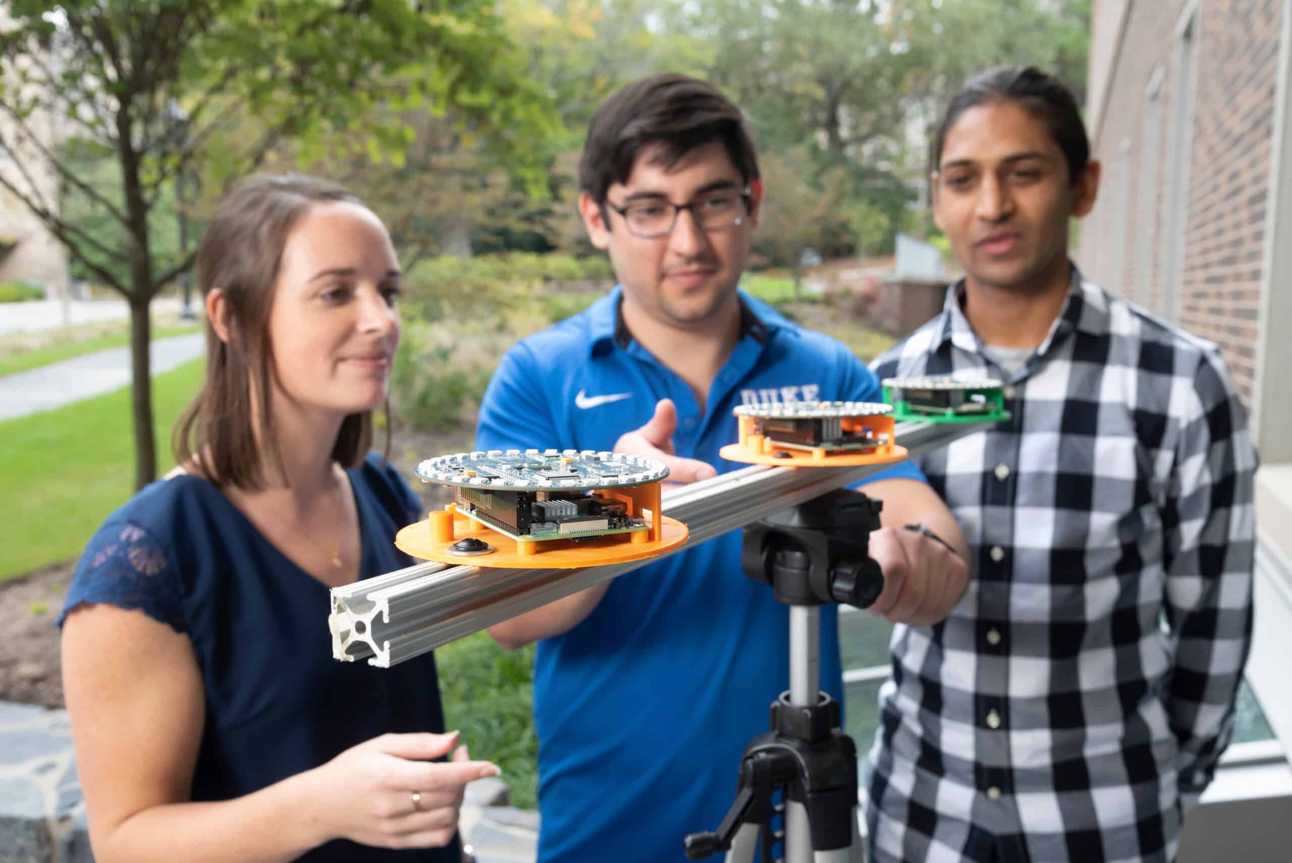 students in the Duke CEI lab work on equipment