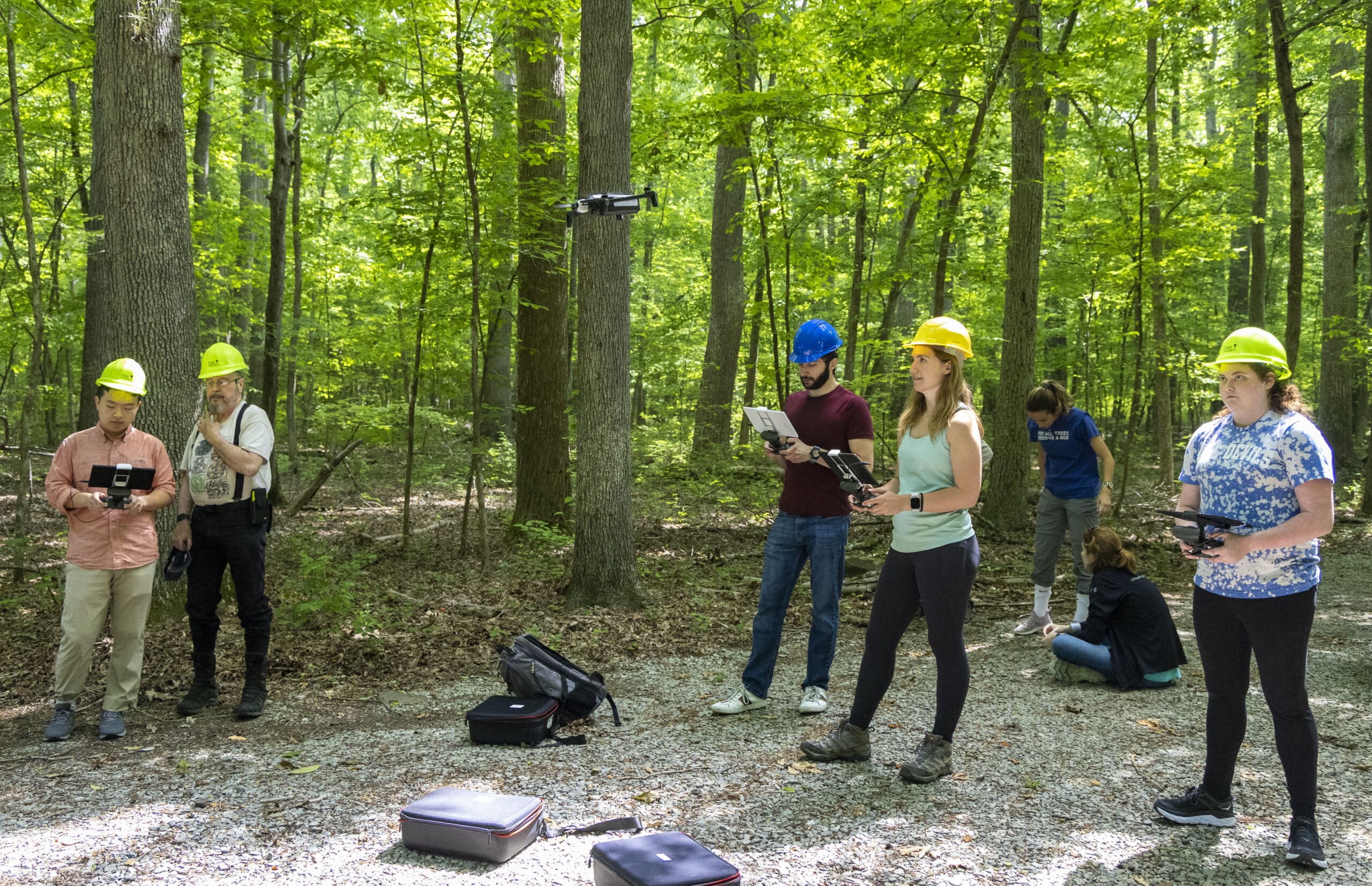 students work on drones in Duke Forest