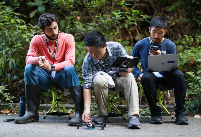 Recent Duke Engineering graduates Achilles Dabrowski (ECE/CS), Alex Xu (ECE/CS) and Timothy Ho (BME/CS) team up on a drone flight during the XPRIZE Rainforest competition semifinals in Singapore.