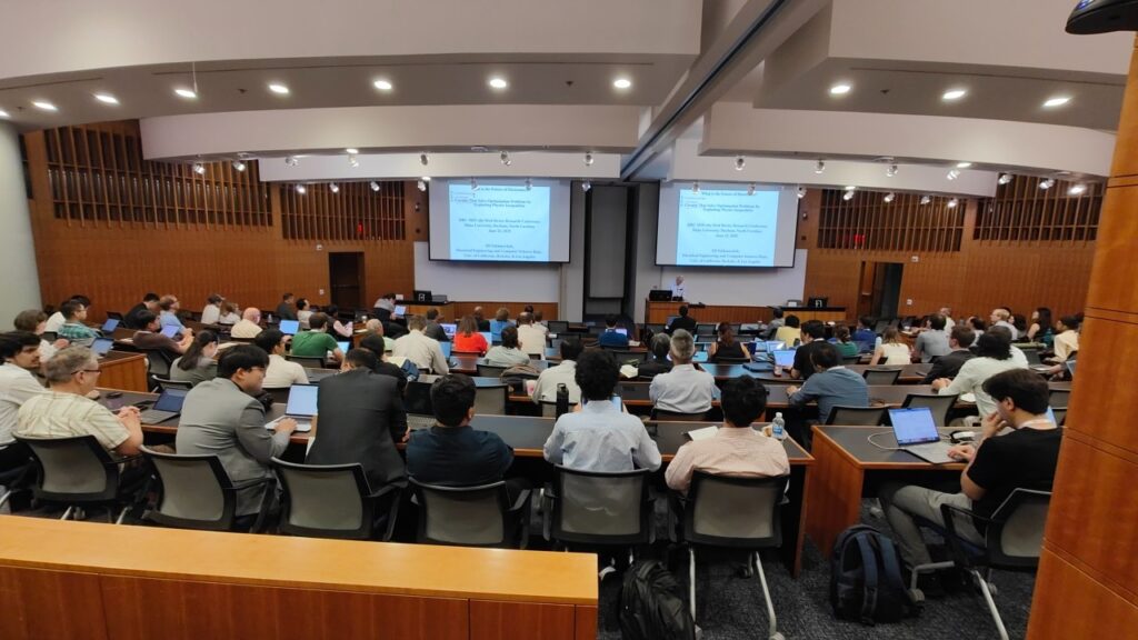 A lecture hall full of people at the 83rd Device Research Conference.